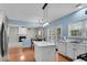 Open concept kitchen with stainless steel appliances and view into a cozy living space at 3925 Tugaloo River Dr, Duluth, GA 30097