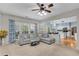 Spacious living room flows to the kitchen, with a comfortable gray sectional sofa at 3925 Tugaloo River Dr, Duluth, GA 30097