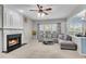 Inviting living room with fireplace, plush gray sofa, and plenty of natural light at 3925 Tugaloo River Dr, Duluth, GA 30097