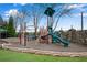 Community playground featuring various climbing structures, a slide, and a picnic table at 3925 Tugaloo River Dr, Duluth, GA 30097