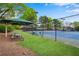 Community tennis courts with benches, covered picnic tables, and perimeter fencing at 3925 Tugaloo River Dr, Duluth, GA 30097