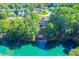 Aerial lake view featuring a backyard and home nestled in the trees with direct water access and a tranquil setting at 5675 Habersham Vly, Suwanee, GA 30024