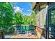 Relaxing back porch view surrounded by lush greenery, featuring a cozy seating area at 5675 Habersham Vly, Suwanee, GA 30024