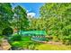 Beautiful backyard oasis with putting green, lake and wooded views, perfect for relaxation and outdoor enjoyment at 5675 Habersham Vly, Suwanee, GA 30024