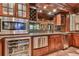 The bar area features wooden cabinets, a wine refrigerator, a microwave, a sink, and granite countertops at 5675 Habersham Vly, Suwanee, GA 30024