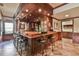The elegant home bar features wood accents, tiled floors, and seating for guests at 5675 Habersham Vly, Suwanee, GA 30024