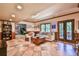 Spacious basement features neutral paint colors, tiled floors, and comfortable seating near the french doors at 5675 Habersham Vly, Suwanee, GA 30024
