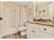 This bathroom has a shower and bath, a marble-style vanity, and neutral paint colors at 5675 Habersham Vly, Suwanee, GA 30024