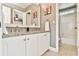 Clean bathroom with double vanity featuring granite countertops and a bright tile shower at 5675 Habersham Vly, Suwanee, GA 30024