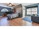 Comfortable bedroom with hardwood floors, a ceiling fan, and large window with natural light at 5675 Habersham Vly, Suwanee, GA 30024