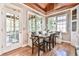 Cozy breakfast nook with built-in bench seating, wood plank ceilings, and access to the screened patio at 5675 Habersham Vly, Suwanee, GA 30024