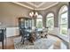 Elegant dining room with a large wooden table, bench, and traditional chandelier for a cozy and stylish setting at 5675 Habersham Vly, Suwanee, GA 30024
