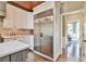 Modern kitchen features stainless steel appliances, white cabinetry, and a decorative tile backsplash, providing ample storage at 5675 Habersham Vly, Suwanee, GA 30024