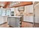 Gourmet kitchen with custom cabinets, stainless steel appliances, central island, and wood planked ceilings at 5675 Habersham Vly, Suwanee, GA 30024