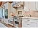 Chef's kitchen includes a professional-grade Wolf range, custom cabinetry, and elegant countertops, perfect for cooking at 5675 Habersham Vly, Suwanee, GA 30024