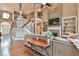 Cozy living room features a stone fireplace, built-in shelving, and hardwood floors, adjacent to the staircase at 5675 Habersham Vly, Suwanee, GA 30024