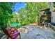 Stone patio with outdoor seating and mature landscaping perfect for entertaining at 5675 Habersham Vly, Suwanee, GA 30024