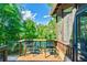 Covered porch featuring outdoor seating with lovely views of the lush yard and trees at 5675 Habersham Vly, Suwanee, GA 30024