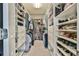 Spacious walk-in closet featuring custom shelving, drawers, and ample storage space at 5675 Habersham Vly, Suwanee, GA 30024
