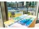 Close-up of a table, inside, with a view through the windows to the outside activity spaces at 10 Perimeter Summit Ne Blvd # 4315, Brookhaven, GA 30319