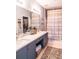 Bathroom featuring double vanity with great lighting, large mirror, and decorative shower curtain at 10 Perimeter Summit Ne Blvd # 4315, Brookhaven, GA 30319