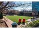 Community lawn area with open seating, red Adirondack chairs, landscaping and a community building in a park-like setting at 10 Perimeter Summit Ne Blvd # 4315, Brookhaven, GA 30319