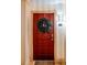 Inviting red front door adorned with a wreath, complemented by modern lighting and the address number at 10 Perimeter Summit Ne Blvd # 4315, Brookhaven, GA 30319