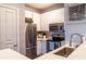 Modern kitchen featuring stainless steel appliances, white cabinetry and ample counter space at 10 Perimeter Summit Ne Blvd # 4315, Brookhaven, GA 30319