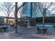 Outdoor seating in the community with shaded benches, tables, and seating overlooking a pickleball court in a park-like setting at 10 Perimeter Summit Ne Blvd # 4315, Brookhaven, GA 30319