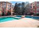 Community pool with a clear view, surrounded by lounge chairs and trees, set against the backdrop of the building at 10 Perimeter Summit Ne Blvd # 4315, Brookhaven, GA 30319