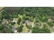 Aerial view of a home nestled in a tranquil, tree-lined neighborhood with winding roads at 123 Nelson Street, Newborn, GA 30056