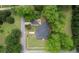 Aerial view of home with outbuilding and abundant surrounding trees in a quiet neighborhood at 123 Nelson Street, Newborn, GA 30056