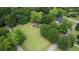 An aerial perspective showcases a property nestled amongst lush greenery, surrounded by neighboring houses at 123 Nelson Street, Newborn, GA 30056