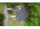 Aerial view of a charming home with a well-maintained roof, driveway, detached garage, and a spacious yard at 123 Nelson Street, Newborn, GA 30056