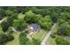 Aerial view showing the home with mature trees, lush landscaping, and a well-maintained yard at 123 Nelson Street, Newborn, GA 30056