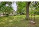 Spacious backyard with a large tree and a distant view of the home at 123 Nelson Street, Newborn, GA 30056