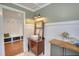 Stylish bathroom featuring vintage-inspired vanity, custom lighting, and views to the mudroom at 123 Nelson Street, Newborn, GA 30056