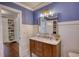 Bathroom vanity with marble countertops and a doorway that shows built-in shelves at 123 Nelson Street, Newborn, GA 30056