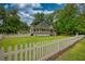 Quaint home with a welcoming porch and a charming white picket fence creates a picture-perfect scene at 123 Nelson Street, Newborn, GA 30056