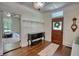 Entryway with wooden floors, detailed trim, and a decorative front door at 123 Nelson Street, Newborn, GA 30056