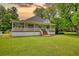 Charming one-story home with a welcoming porch and large front lawn at 123 Nelson Street, Newborn, GA 30056