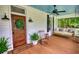 Cozy front porch with a swing and wooden door at 123 Nelson Street, Newborn, GA 30056