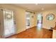 Hallway with doors to the laundry room, outside, and a hall mirror at 123 Nelson Street, Newborn, GA 30056