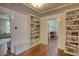 Hallway featuring hardwood floors, a built-in bench, and custom shelving at 123 Nelson Street, Newborn, GA 30056
