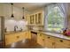 Bright kitchen featuring stainless steel appliances, granite counters, custom cabinets and modern lighting at 123 Nelson Street, Newborn, GA 30056