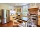 Elegant kitchen featuring stainless steel appliances, granite counters, custom cabinets and herringbone tile accents at 123 Nelson Street, Newborn, GA 30056