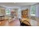 Charming kitchen with a dining table, an island, stainless steel appliances, and windows adorned with white curtains at 123 Nelson Street, Newborn, GA 30056