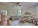 Inviting living room filled with natural light, a fireplace, and a view into the adjoining kitchen at 123 Nelson Street, Newborn, GA 30056