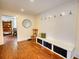 Convenient mudroom with a storage bench, coat hooks, and hardwood flooring at 123 Nelson Street, Newborn, GA 30056