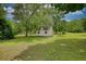Outbuilding nestled in a lush, green landscape is perfect for storage or a hobby space at 123 Nelson Street, Newborn, GA 30056